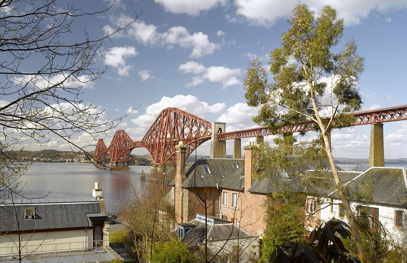The Forth Bridge (the rail bridge) A view over rooftops to the Forth Bridge on a sunny day