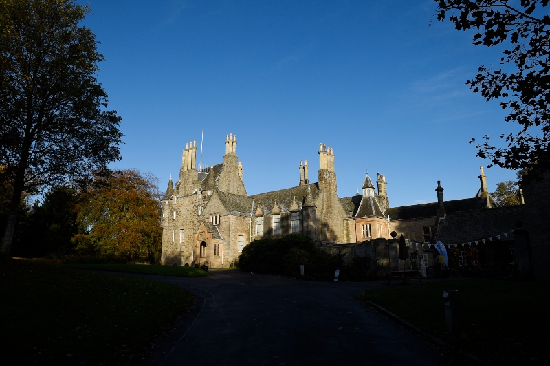 Exterior of Lauriston Castle on a sunny autumnal day with blue skies.