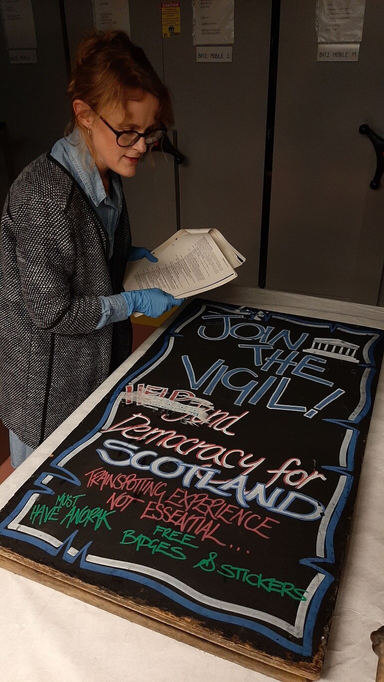 Curator researching a protest placard