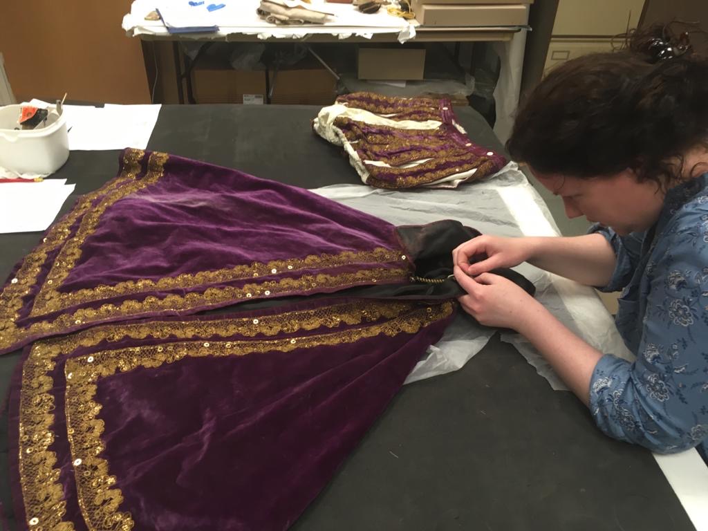 Volunteer Fran sewing a new accession label into a theatrical costume © City of Edinburgh Council Museums & Galleries; Museum of Edinburgh