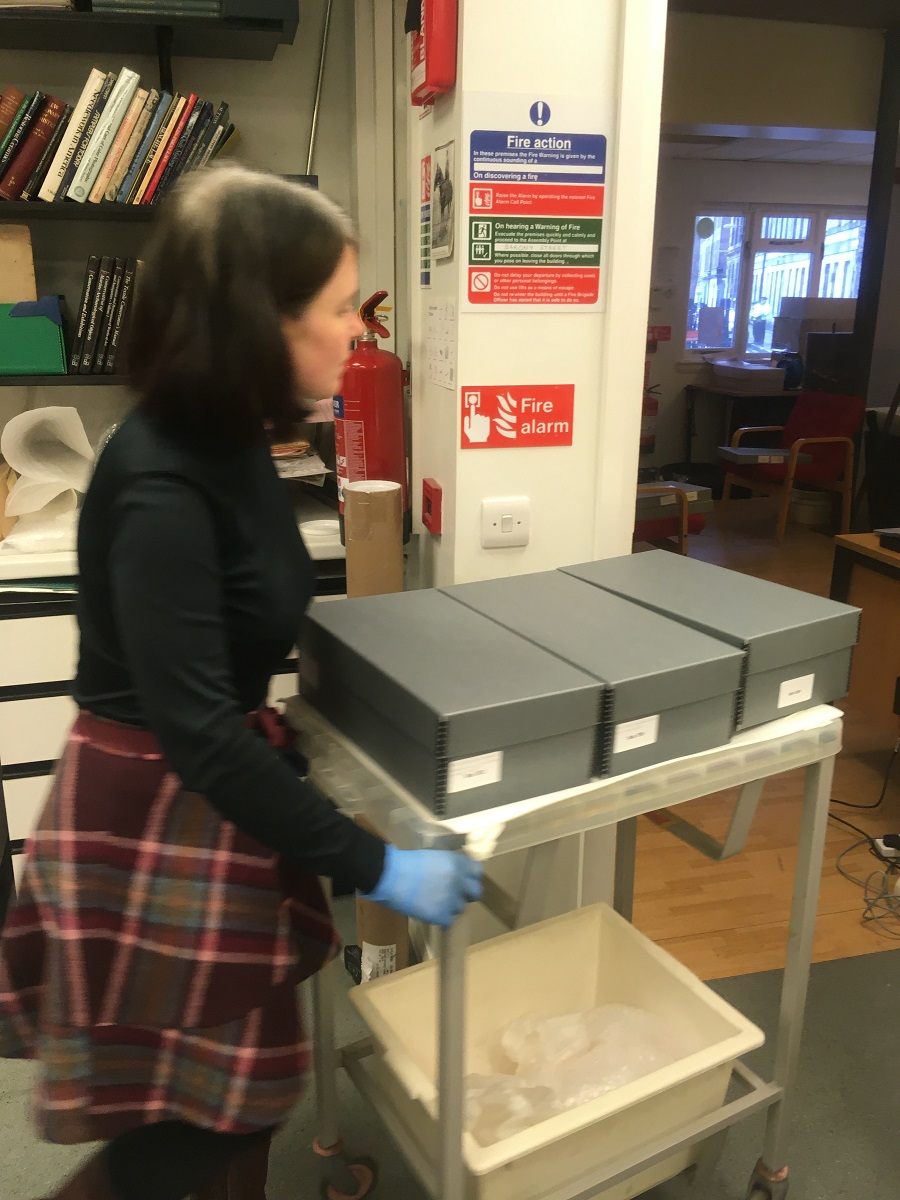 Collections Care Officer Gwen Thomas moves boxes of shoes for photography at the Museum Collections Centre © City of Edinburgh Council Museums & Galleries; Museum Collections Centre