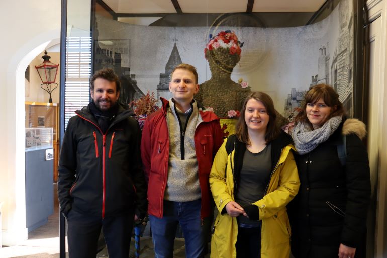 Some of the Auld Reekie Retold team - Nico, Oliver, Suzy and Gabriella – meeting the Burryman in Queensferry Museum, early 2020