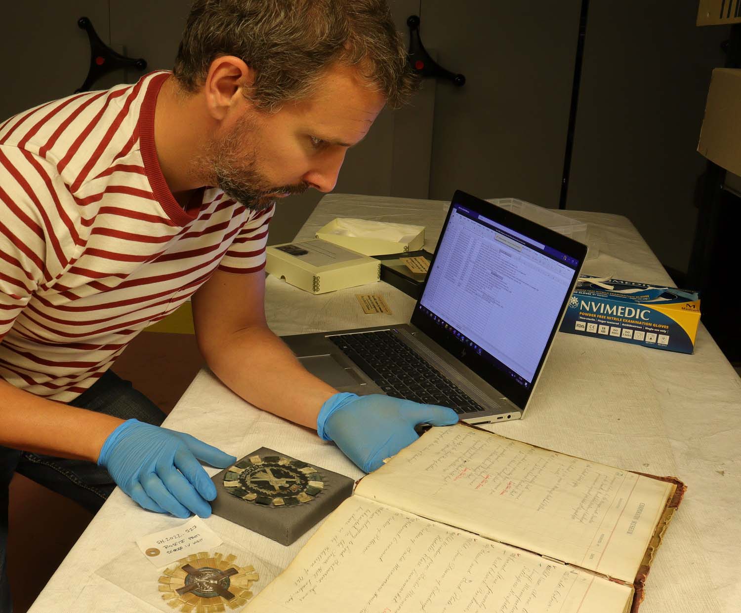 Collections Project Manager Nico Tyack researching the George IV rosettes in the store at the Museum Collections Centre