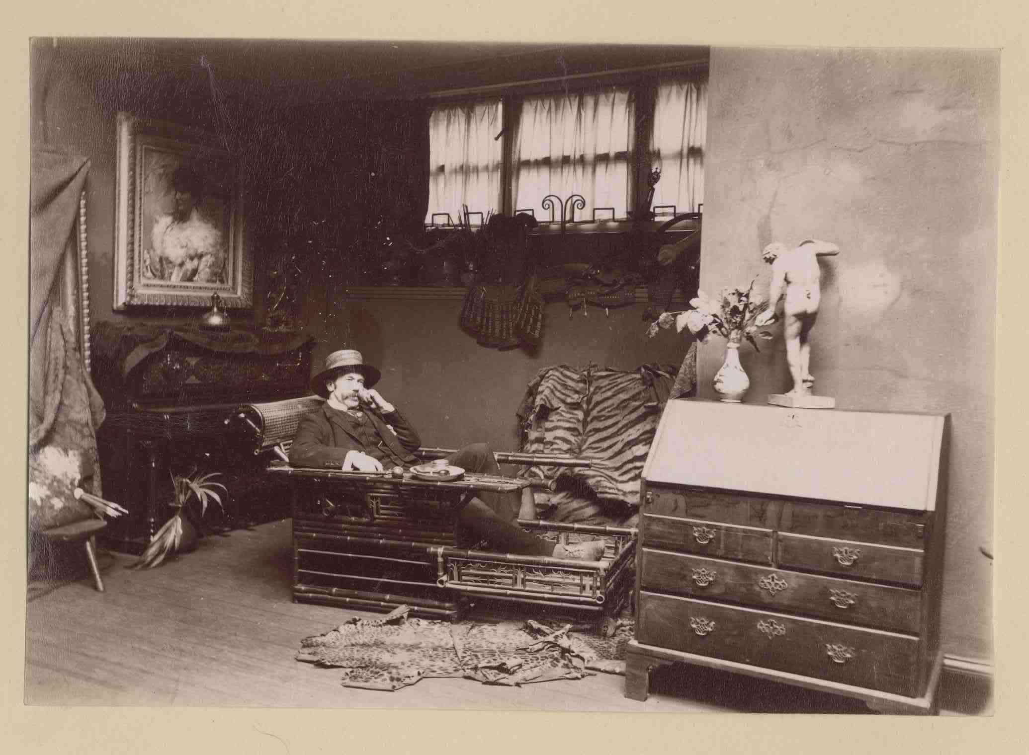 Lauriston photograph album – artist’s studio with man reclining on a travelling couch