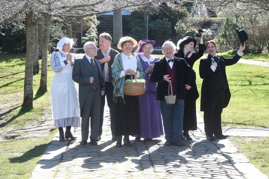 Members of the Edinburgh Living History Group, dressed in Edwardian costume, stand in the grounds of Lauriston Castle