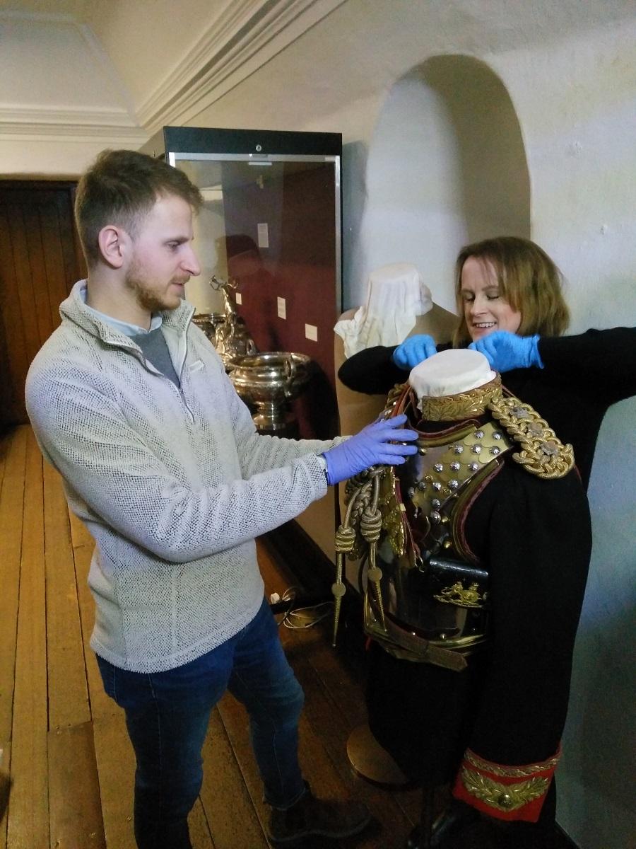 Vicky and Collections Assistant Oliver Taylor installing a mannequin showing Field Marshal Earl Haig’s dress uniform as Colonel of the Royal Horse Guards at the Museum of Edinburgh © City of Edinburgh Council Museums & Galleries; Museum of Edinburgh