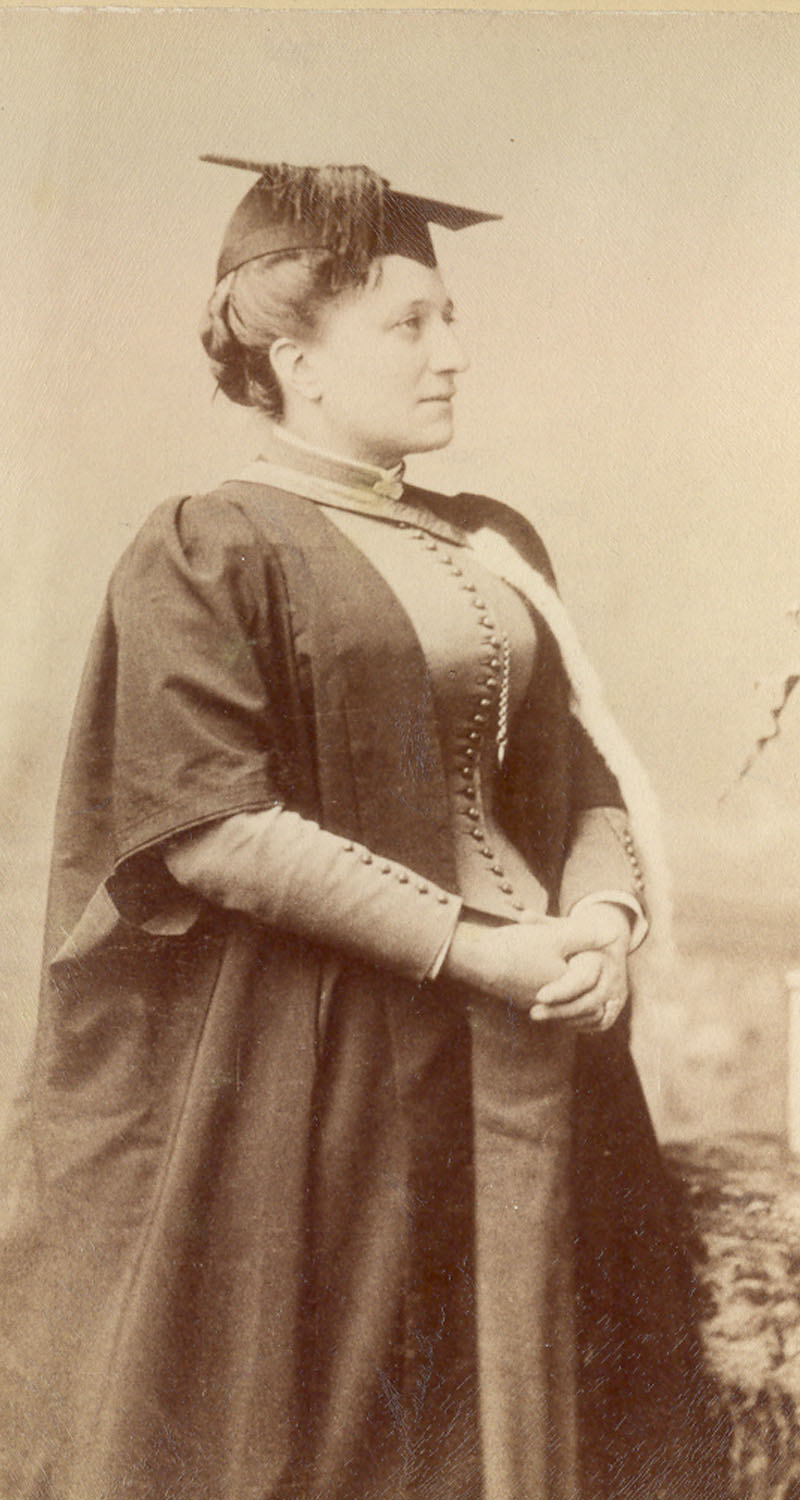 Sepia photograph of a woman in graduation gown and mortarboard hat