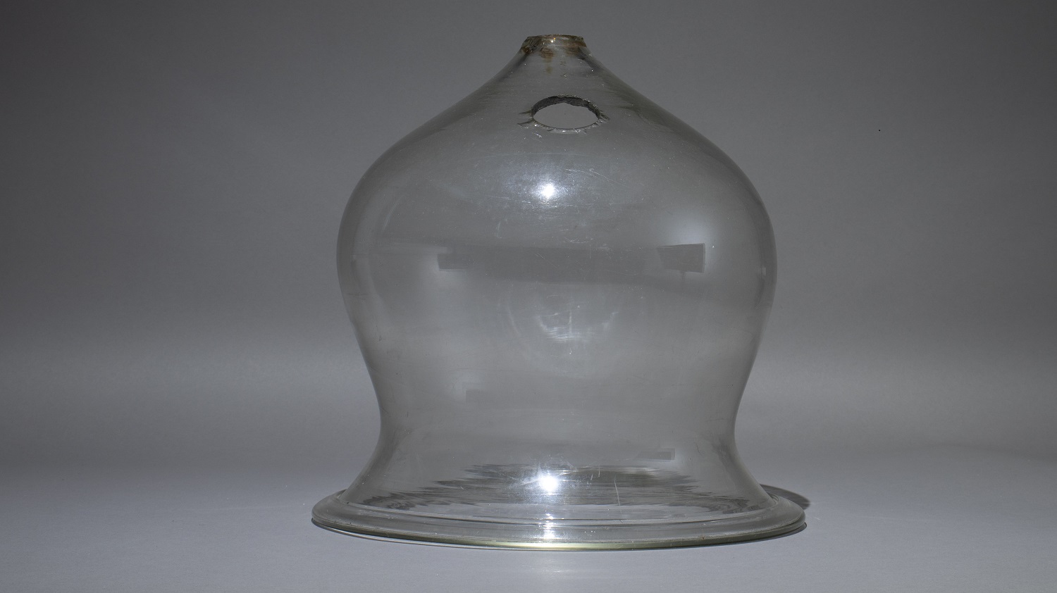 A clear glass globe for fitting over a gas lamp