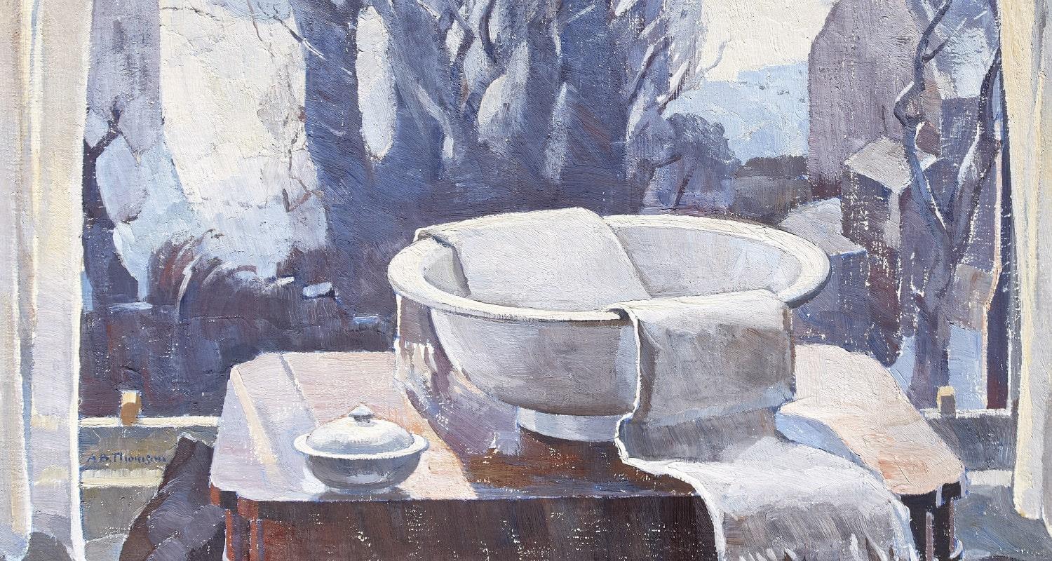 A white shaving bowl, draped with a white towel, sits on a wooden table in front of the window. A pot of shaving soap is also on the table. Beyond the window is a snowy scene of trees and houses