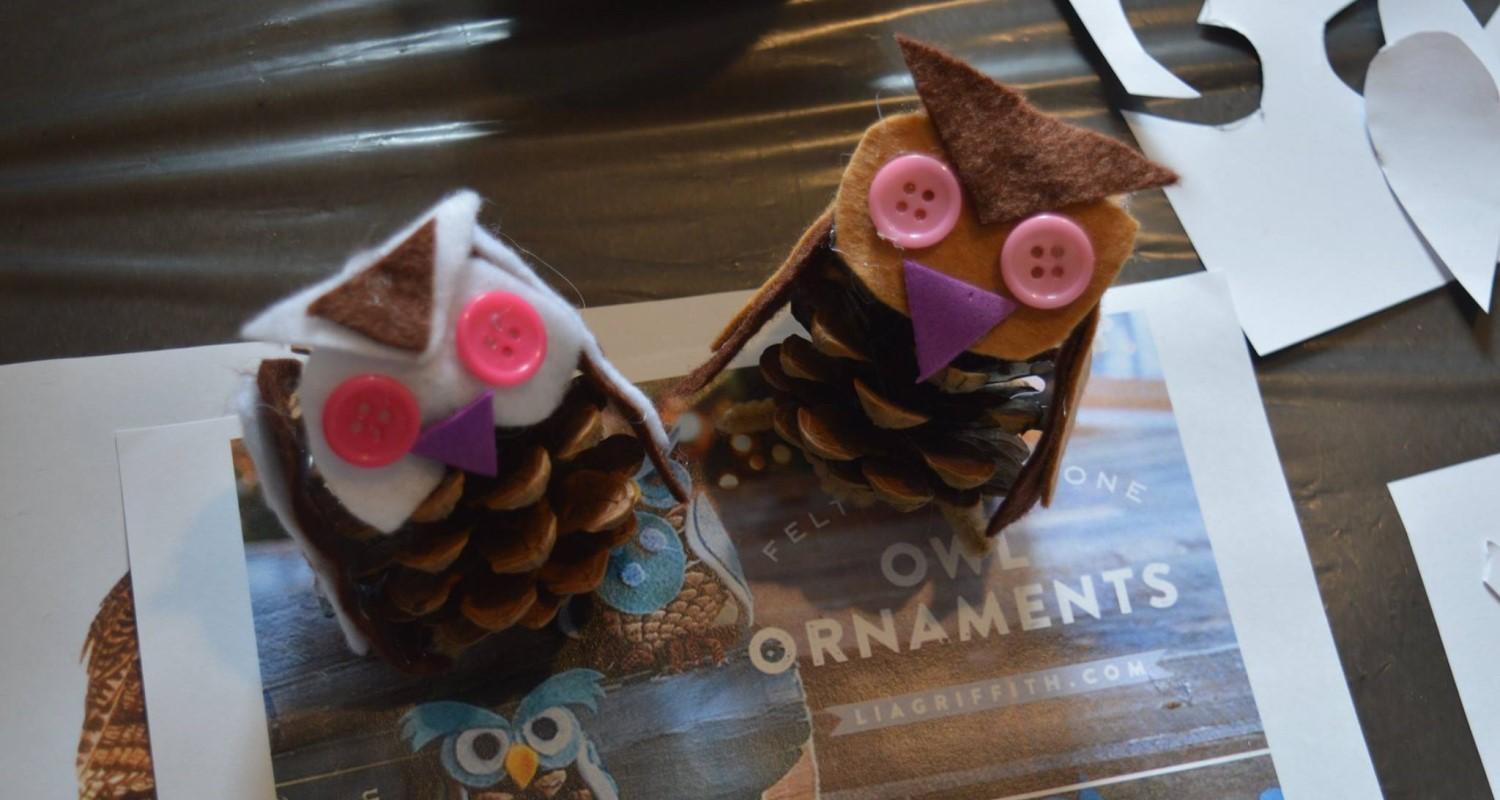 Two owls made from pine cones and buttons