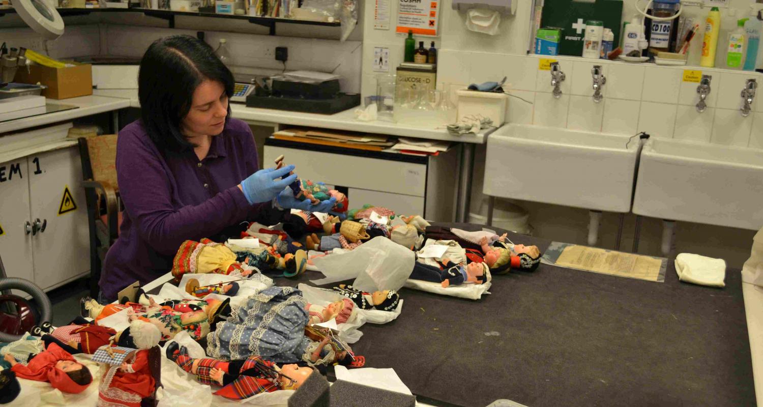 Collections Care Officer assessing costume dolls