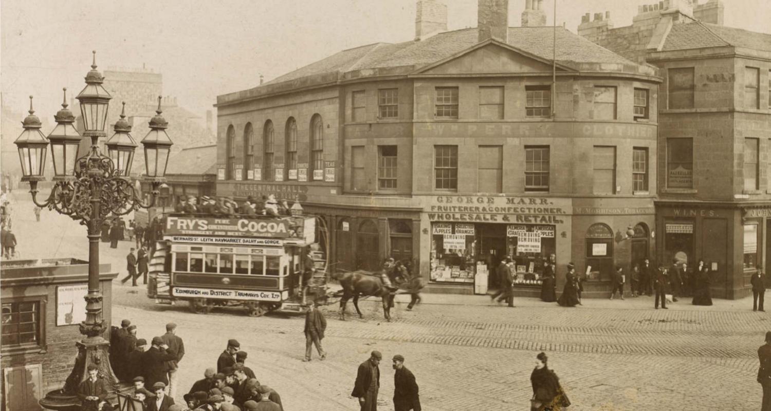 Sepia Photograph, "Foot of Leith Walk". A busy street scene with horse drawn trams and old shops.