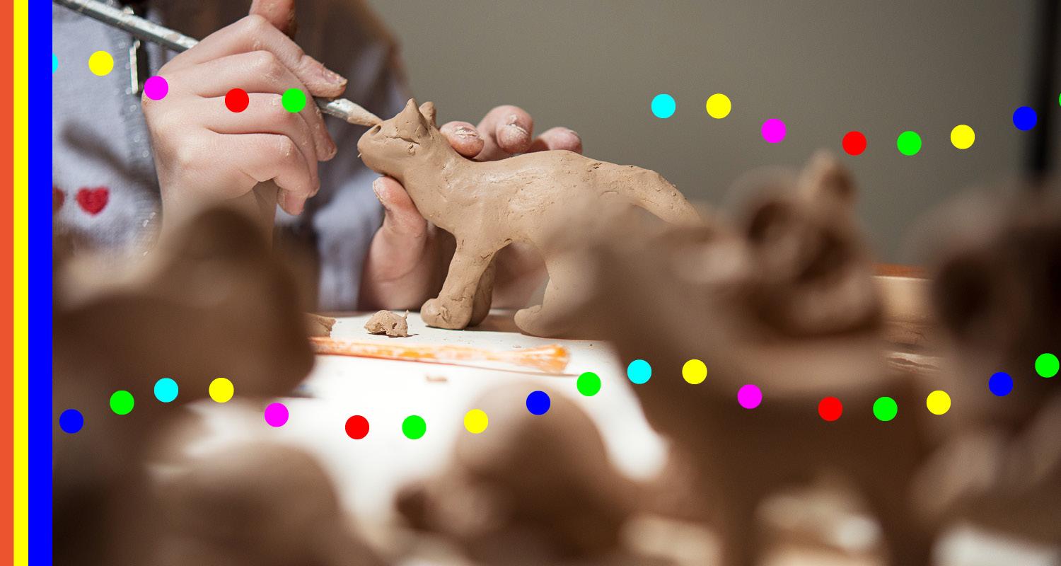 photo of a hand crafting an animal out of clay