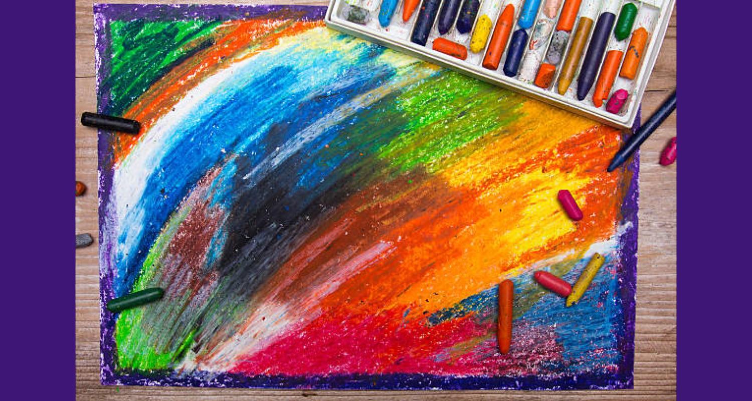 A drawing of multicoloured crayons with purple glitter around the edges of the paper