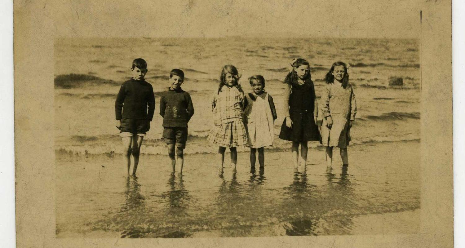 Jean Crawford and a group of friends paddle at the beach