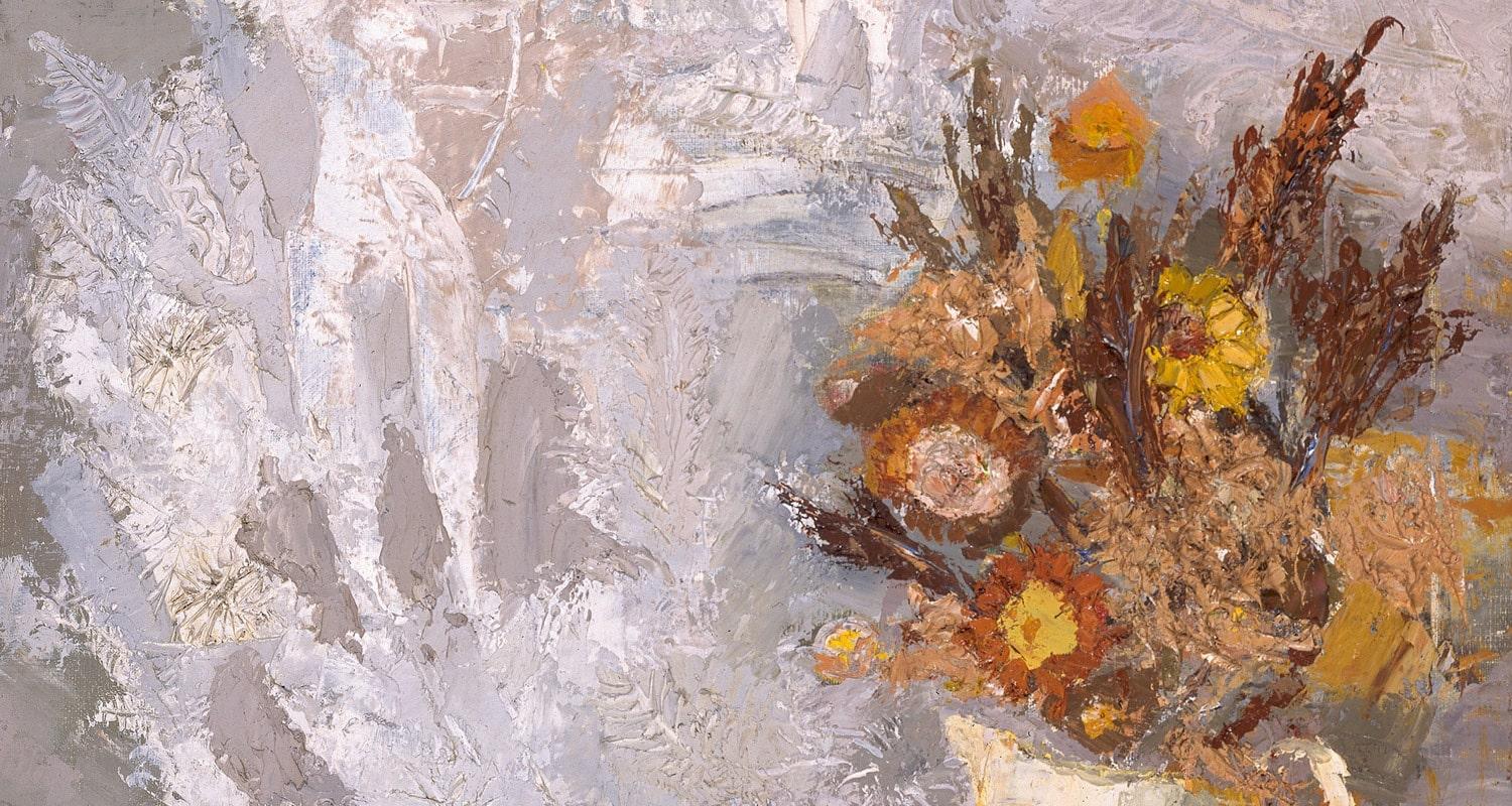 Autumnal flowers in yellow, brown and orange in a white jug. 