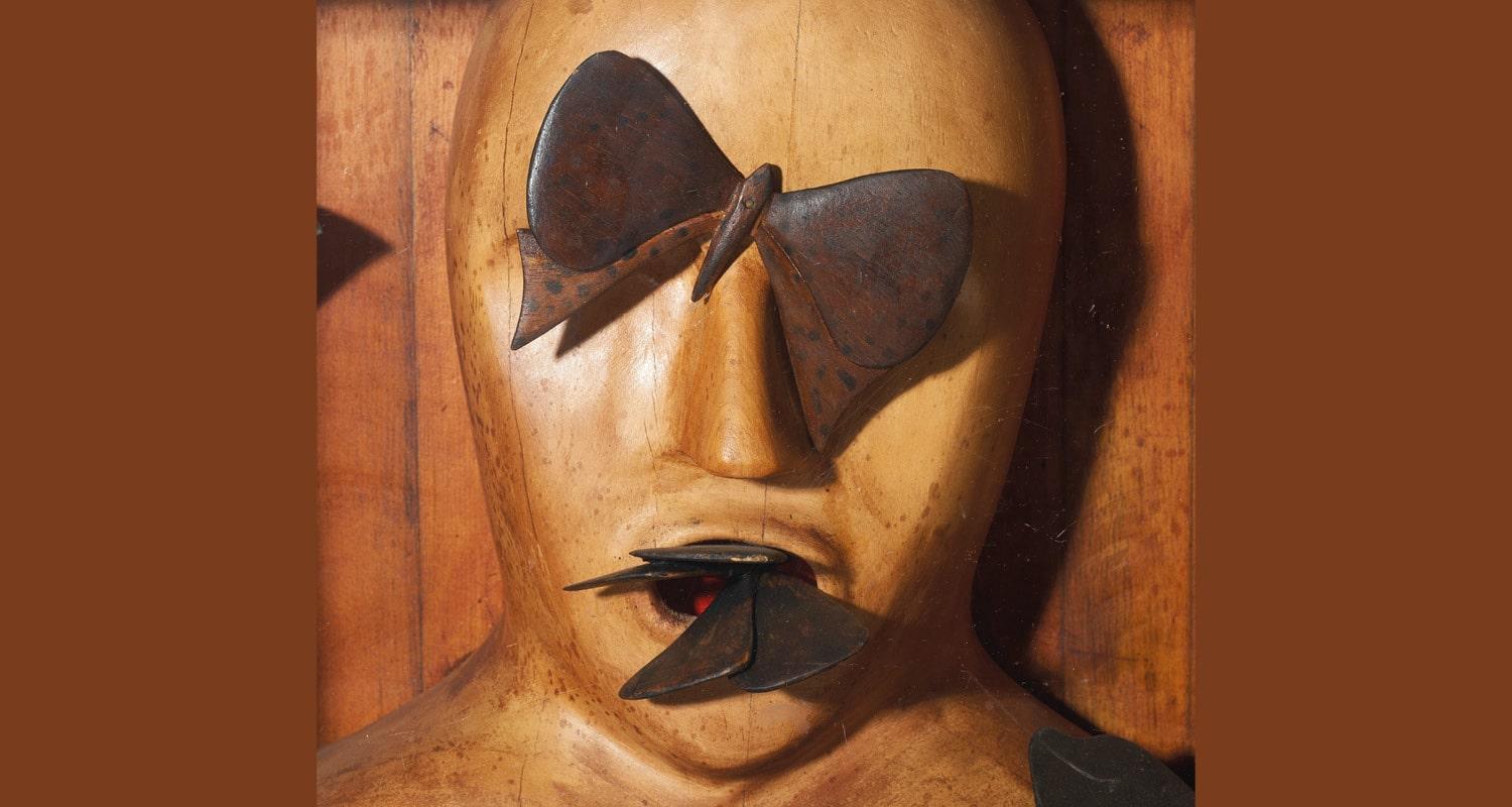 Detail of Will Maclean sculpture - face with butterflies