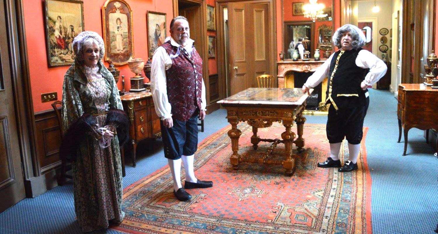 Three members of Edinburgh Living History in Victorian garb standing in a room in Lauriston Castle