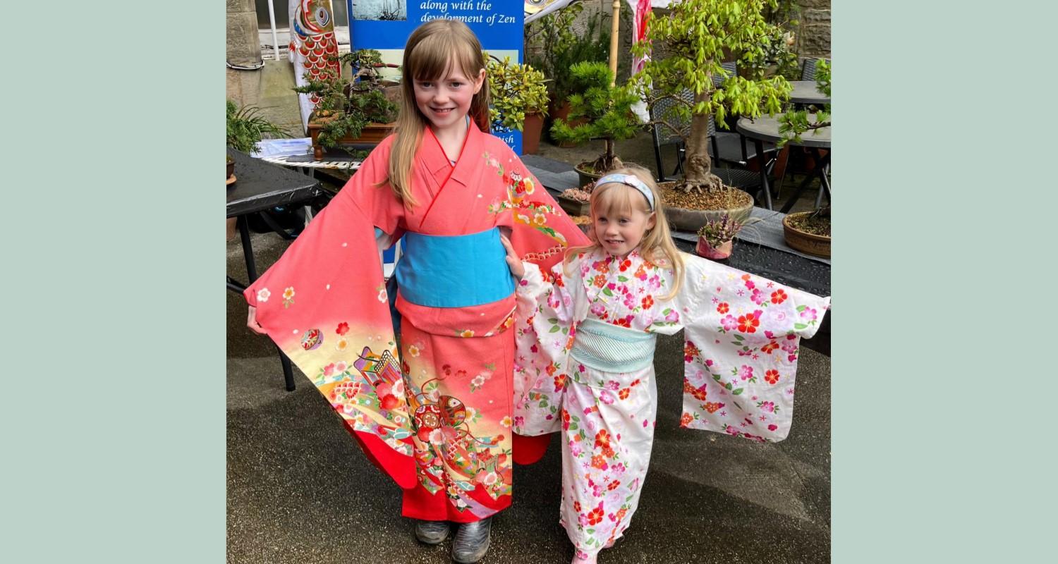 Two little girls wearing kimonos