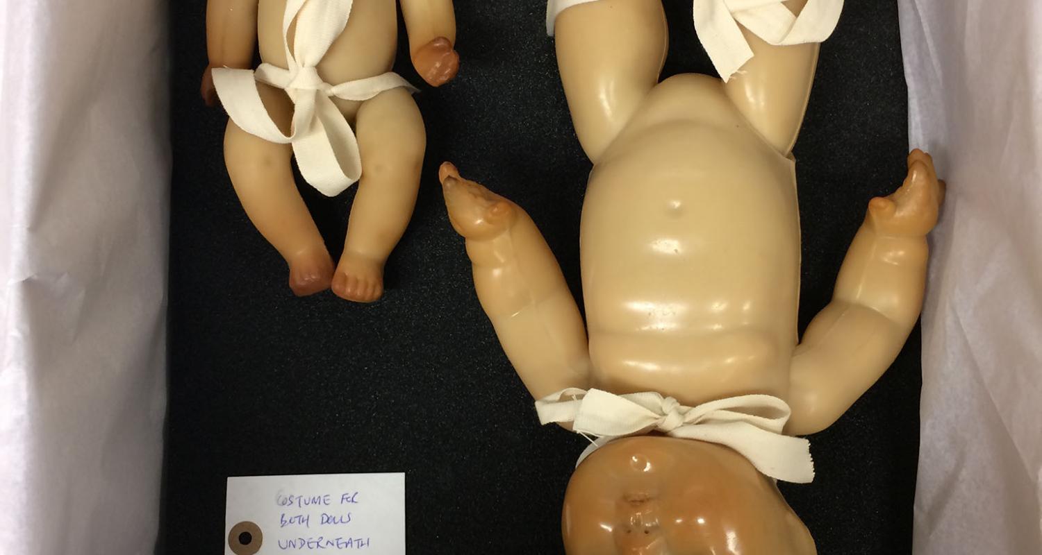 plastic dolls packed for storage in museum store