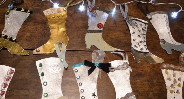 A paper garland of Victorian boots for Christmas.