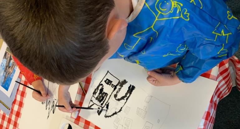 Photo of a child drawing a castle Photo of a child drawing a castle