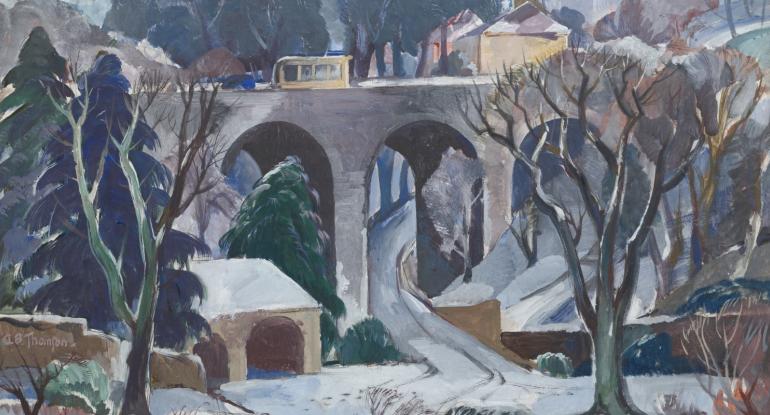 A snowy landscape of Colinton Bridge, showing a bus driving over the bridge with trees and buildings in the foreground beneath the bridge and buildings, trees and hills beyond it