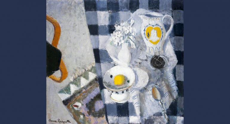 A still life of a black and white tablecloth, spoon, white vase and flowers, white blue and yellow jug, and bowl,, a lemon, and a multicoloured rug, grey carpet and blue chair beneath