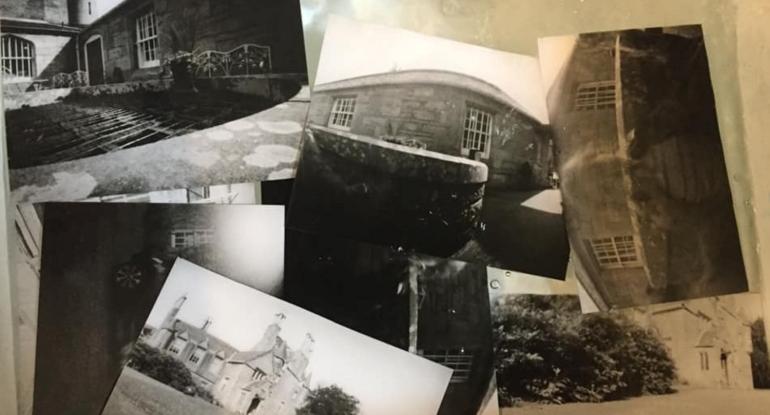 Lots of different black and white photos on a table