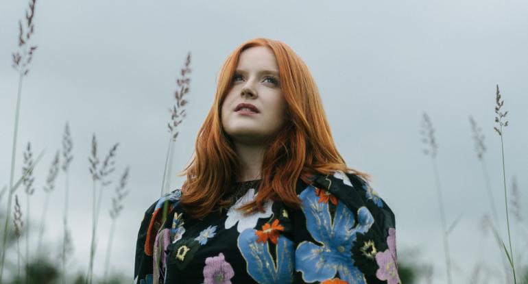 Ceitlin Lilidh wearing a black top with large bold flowers