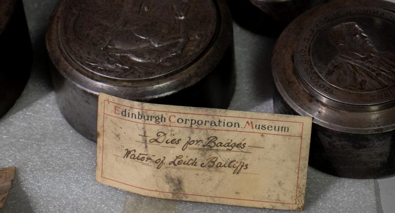 Detail of an old museum label for Water of Leith bailiff badges