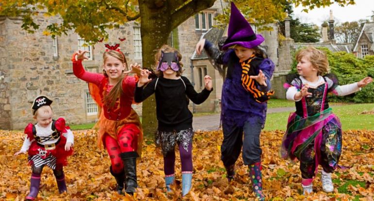 Five children in Hallowe'en costumes, including a pirate, a cat and a witch