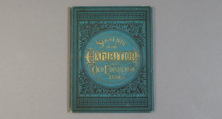 The cover of a blue and gilt book titled "Souvenir of the Exhibition Old Edinburgh 1886"