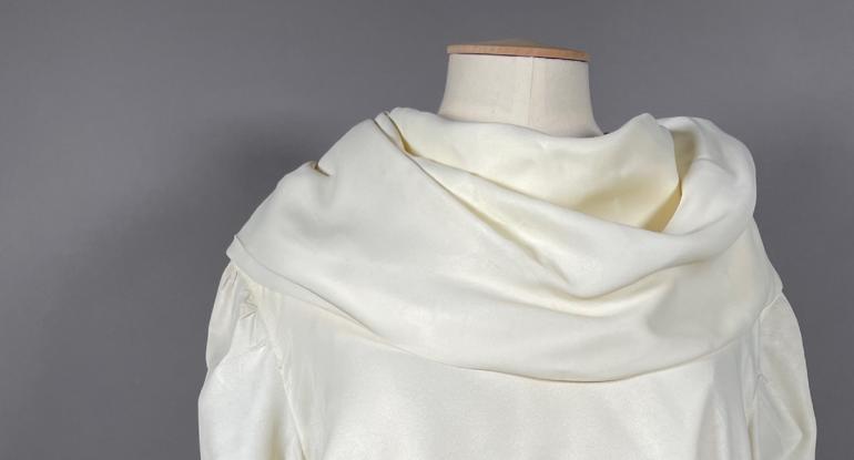 A detail view of the neckline of a Mary Quant blouse on a mannequin