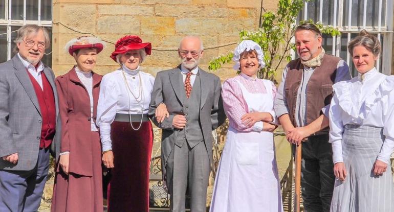 7 members of the Edinburgh Living History group dressed in Edwardian dress 