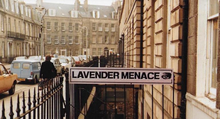 The Lavender Menace sign across the railings at the top of the stairs in Forth Street