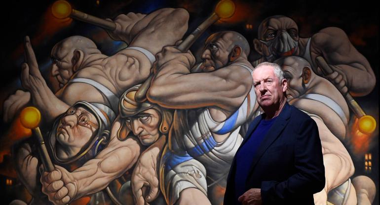 Peter Howson in front of a painting