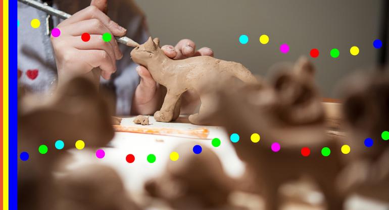 photo of a hand crafting an animal out of clay