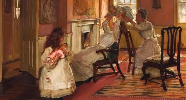 Edwardian family in a room, mother and maid playing with baby, little girl looks on with her doll.