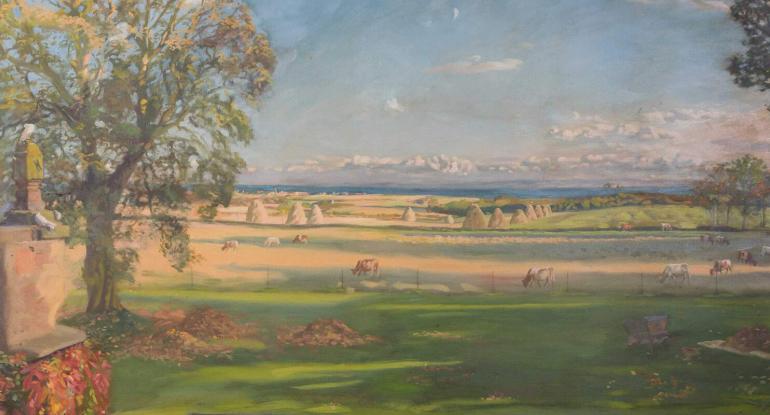 View of a rural landscape with cows and haystacks