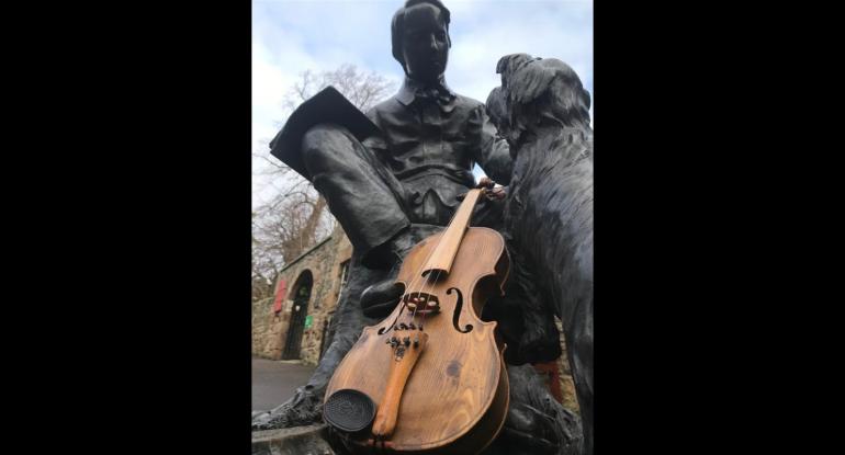 Statue of writer Robert Louis Stevenson in Edinburgh with a violin