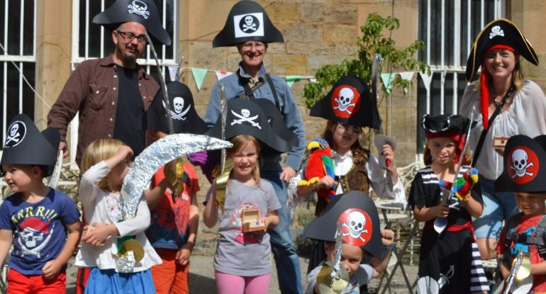 A group of adults and children dressed up as pirates