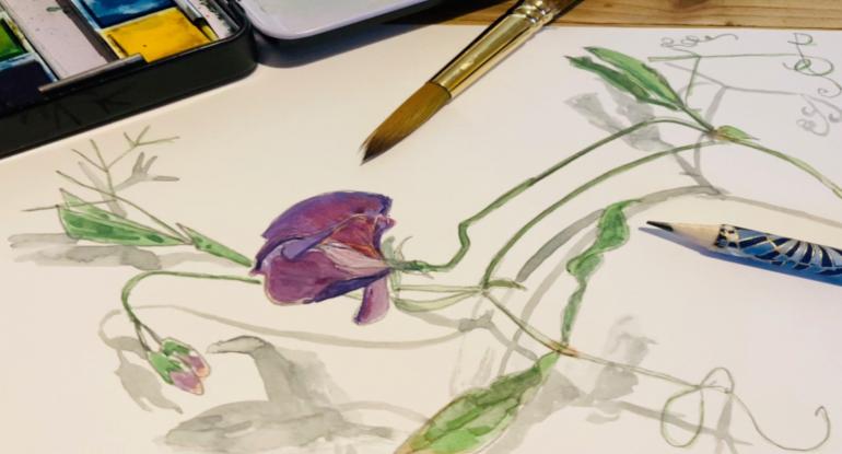 A watercolour painting of a purple flower, with brush, pencil and palette