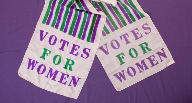 Votes for Women sash in the colours of the  Women's Social Political Union