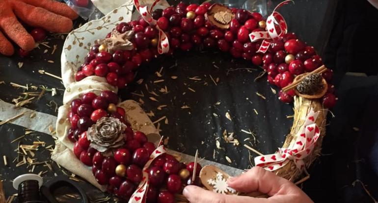 A wreath of cranberries and ribbon