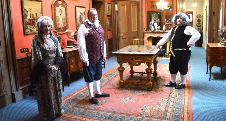 Three members of Edinburgh Living History in Victorian garb standing in a room in Lauriston Castle