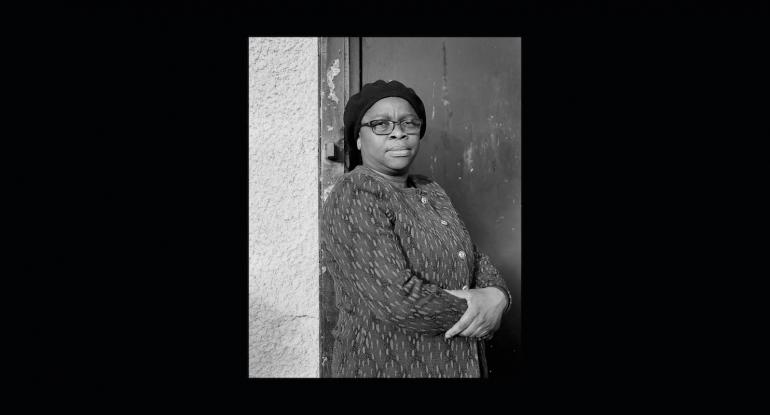 Photograph of a women by a doorway photographed by Paul Duke in North Edinburgh