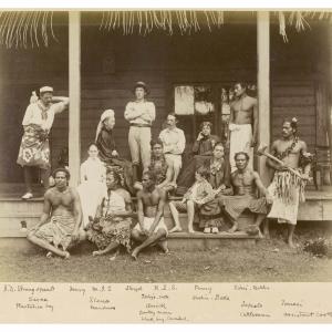 A group of people sitting on the porch of a house on Samoa, Stevenson's family and Samoa natives.
