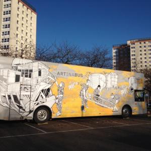 Travelling Gallery parked with two high rise apartment blocks in the background