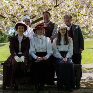 The Edinburgh Living History group dressed in Edwardian costume underneath a blossom tree